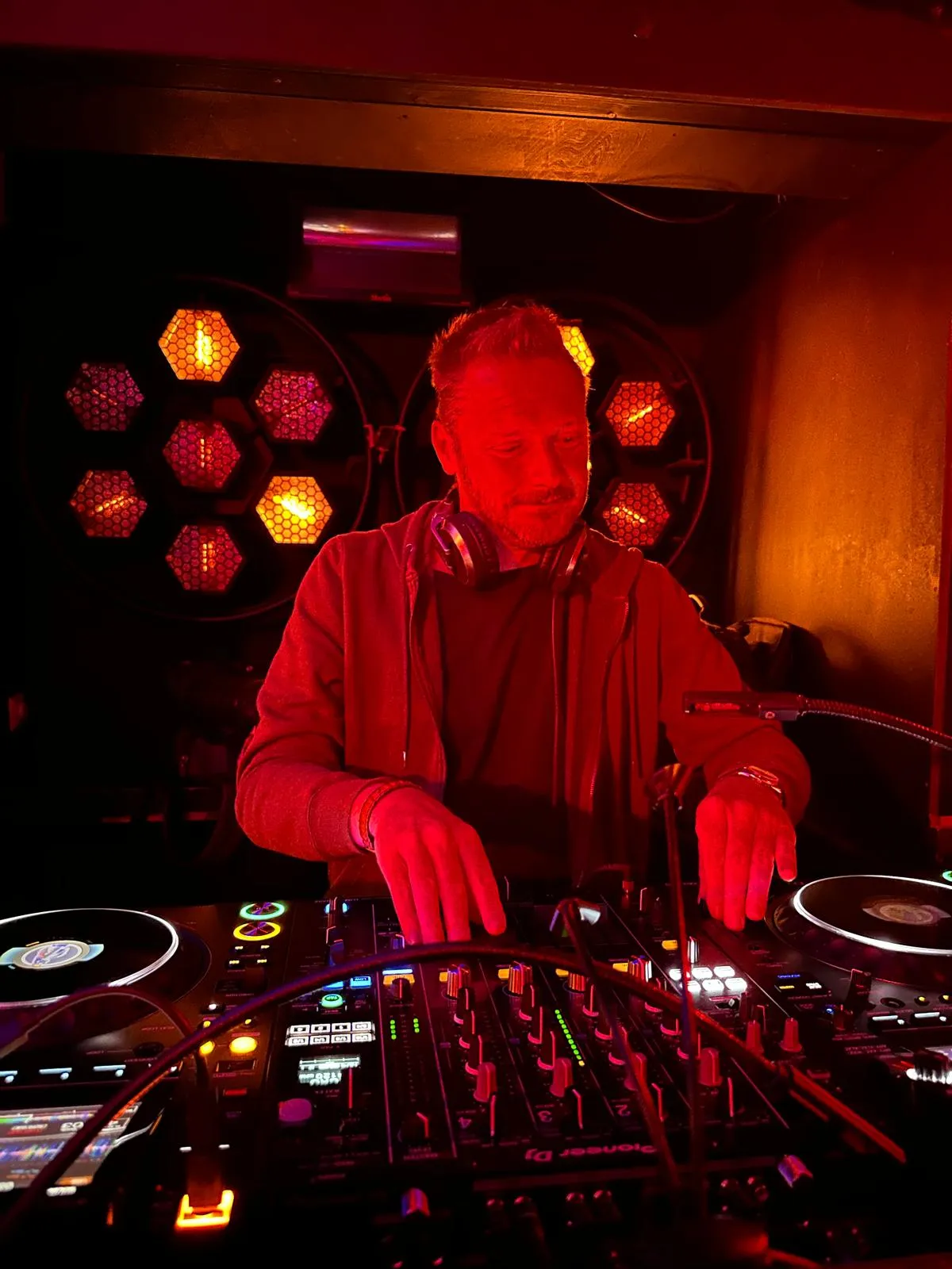 Jack Orange DJ-ing in red stage light